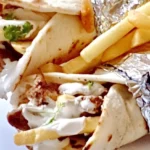 Close up of two easy chicken shawarma wraps with creamy garlic sauce