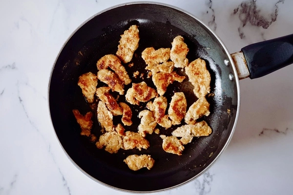 Cooked chicken shawarma chunks in a pan