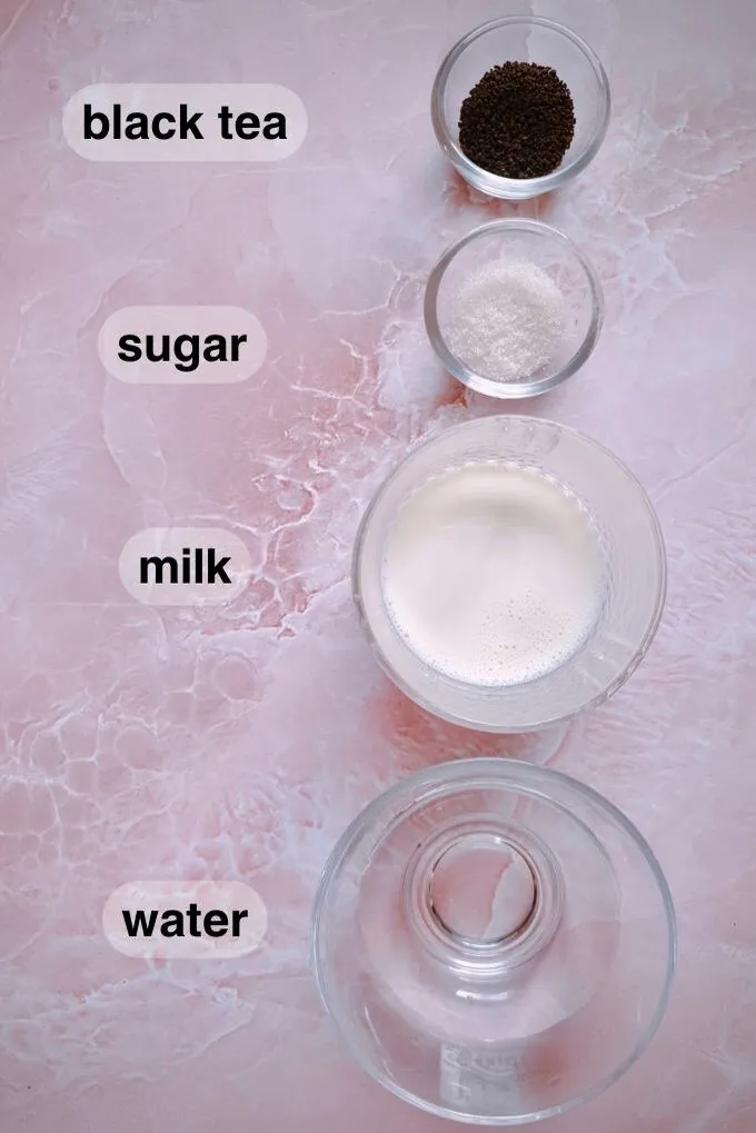 Black tea, sugar, milk and water in separate bowls