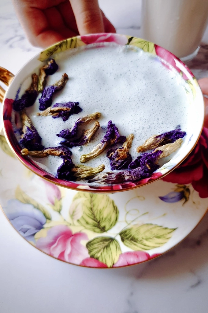 Warm Enchanting Blue Latte Recipe (Super Easy with Butterfly Pea) in a cup with dried blue pea flowers sprinkled on top