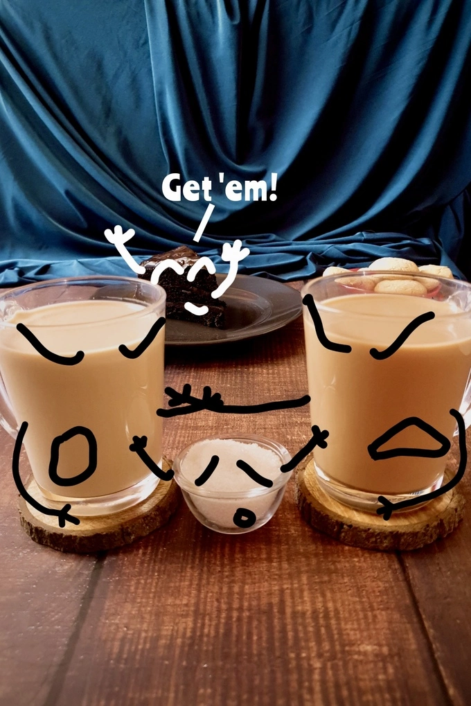 A funny cartoonish representation of two mugs of royal milk tea and regular milk tea fighting with each other