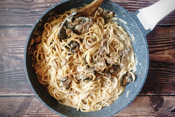 One pot zucchini mushroom pasta with creamy coconut milk sauce in a skillet