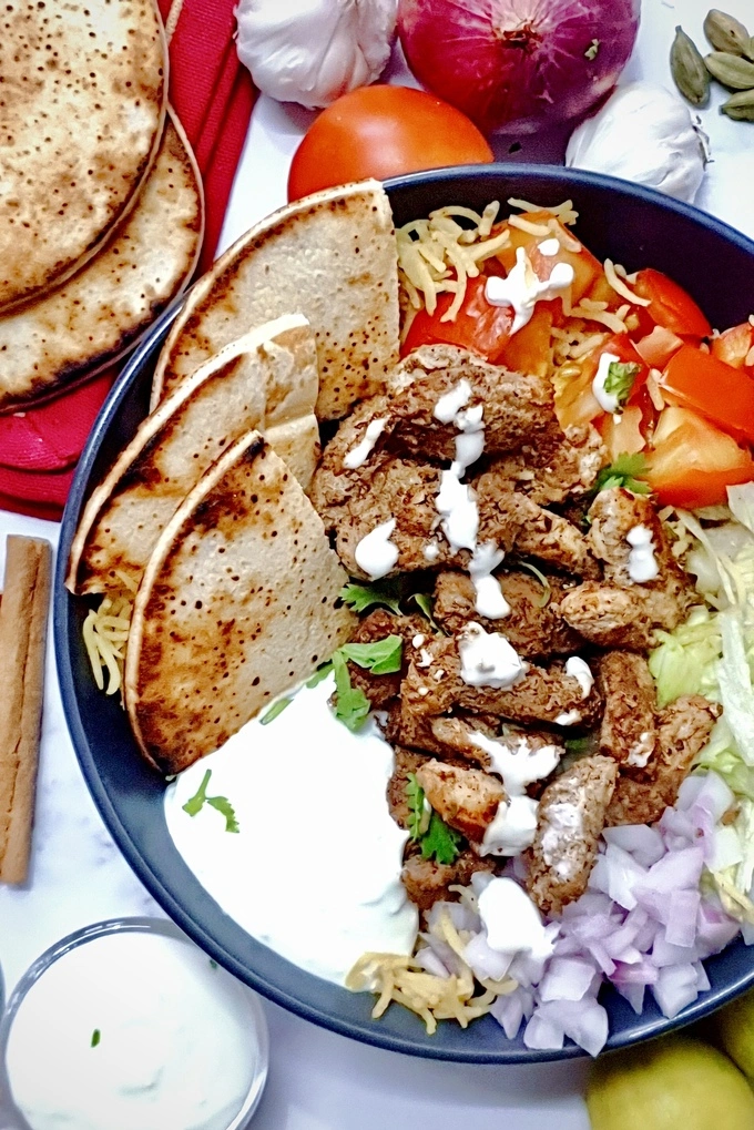 Chicken Shawarma with Garlic Sauce Rice Bowl surrounded by raw ingredients