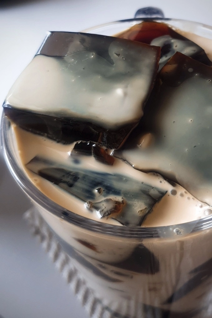 Close up of cubes of Homemade Coffee Jello Recipe with Condensed Milk Cream in a glass mug