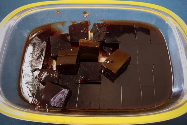 Coffee jelly in a glass tray cut into cubes