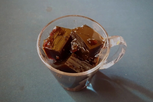 Cubes of coffee jello filled a glass mug