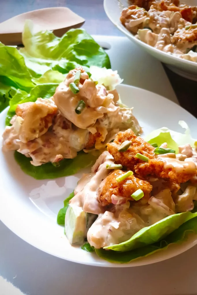Gluten-free chicken salad recipe with fried chicken being served in lettuce cups.